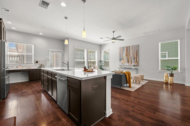 With the kitchen overlooking the living room, it’s easy to stay engaged with family or guests while preparing meals, making this space perfect for both cooking and connecting | Image 17
