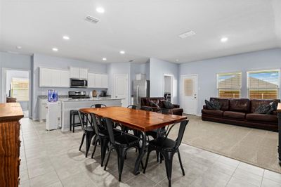 Dining area with light carpet and plenty of natural light | Image 3