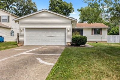 View of front of house featuring a garage and a front lawn | Image 2