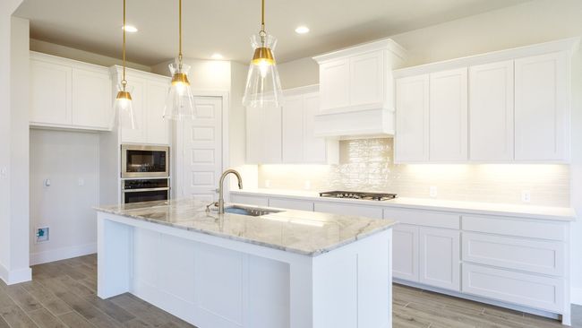 Kitchen featuring appliances with stainless steel finishes, a sink, light wood-type flooring, tasteful backsplash, and recessed lighting | Image 5