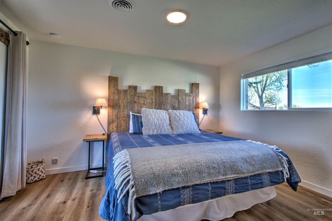 Bedroom with wood finished floors and a textured wall | Image 17