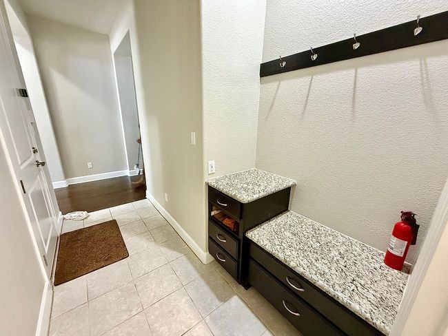 Mudroom with light tile patterned floors and baseboards | Image 18