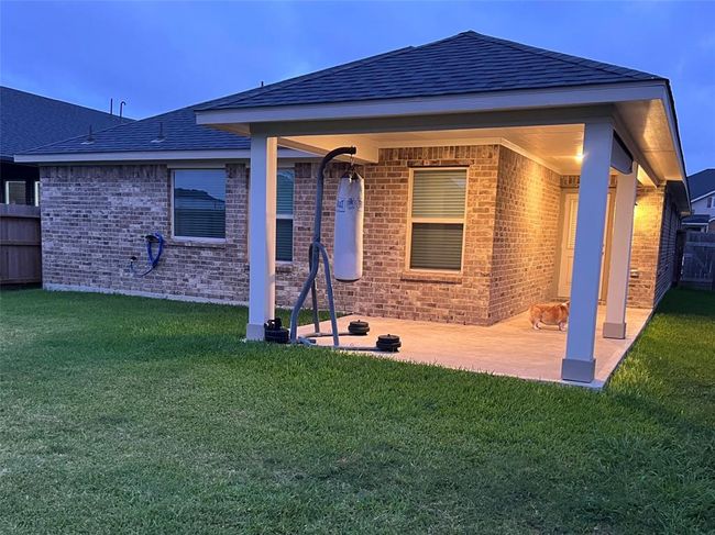 Spacious covered patio, ideal for grilling and family gatherings. | Image 19