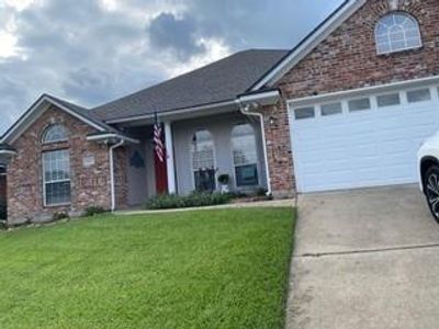 View of front facade featuring a garage and a front lawn | Image 1