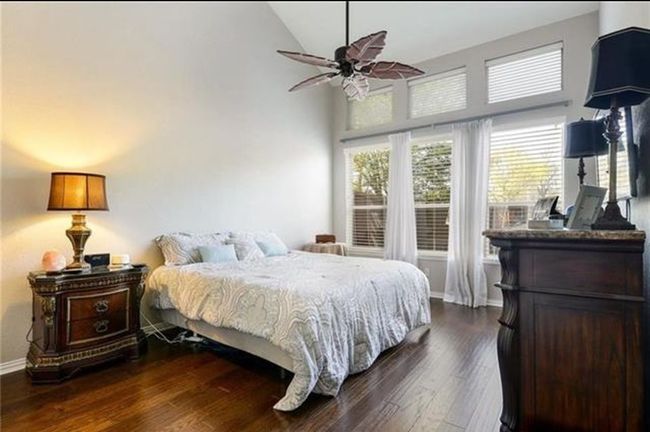 Bedroom with high vaulted ceiling, ceiling fan, and dark wood-type flooring | Image 10