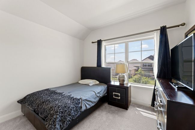 Bedroom with vaulted ceiling, light colored carpet | Image 30