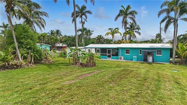 Back of property featuring a lawn and a sunroom | Image 38