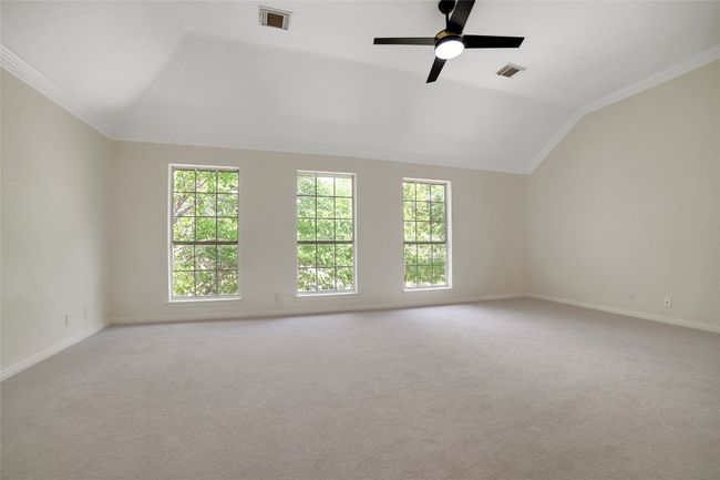 Spare room with vaulted ceiling, plenty of natural light, ornamental molding, baseboards, and carpet floors | Image 30