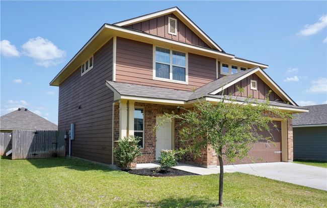 Craftsman inspired home with concrete driveway, board and batten siding, brick siding, roof with shingles, and a garage | Image 19