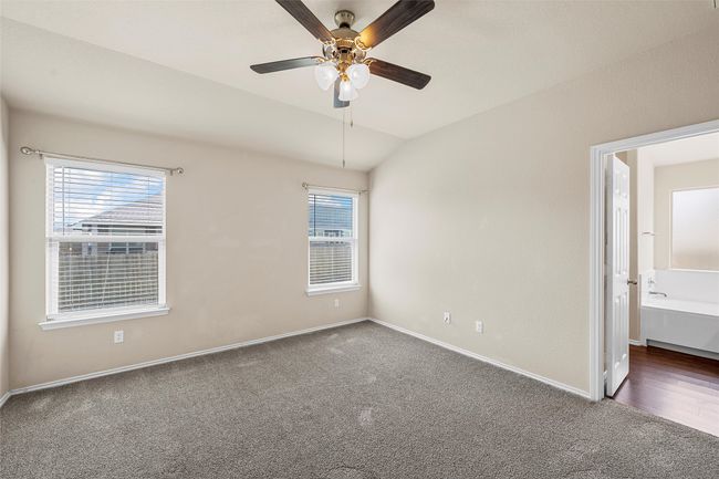 Unfurnished room with carpet, ceiling fan, and lofted ceiling | Image 18