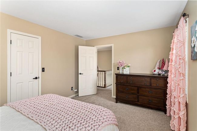Bedroom with light colored carpet | Image 33