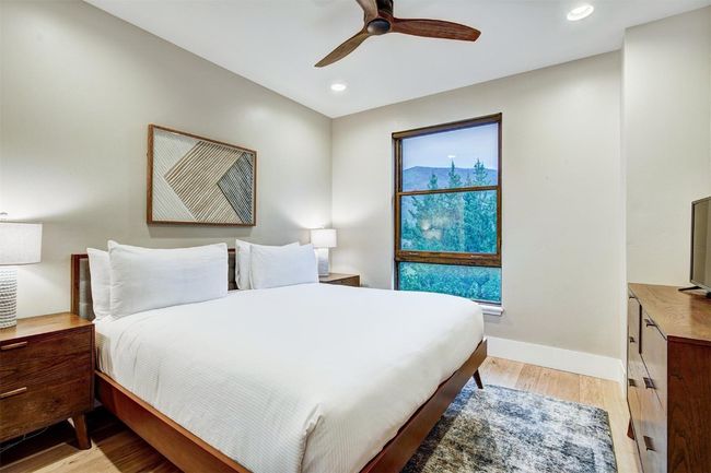 Bedroom with baseboards, light wood-type flooring, ceiling fan, and recessed lighting | Image 21