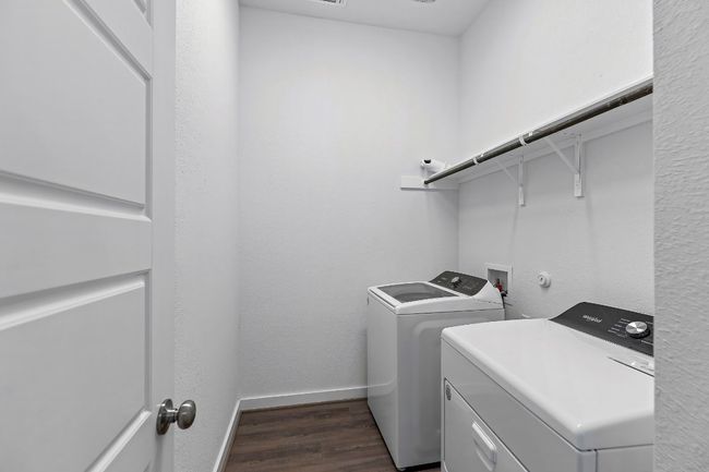 Laundry room with washer and clothes dryer, baseboards, and dark wood-style floors | Image 6