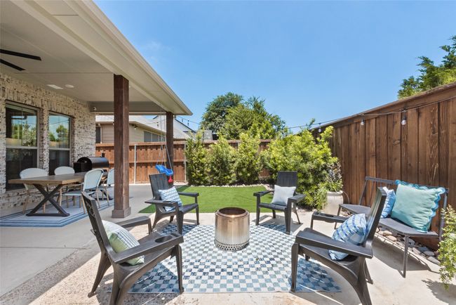 Fenced backyard featuring a patio area and a grill | Image 38