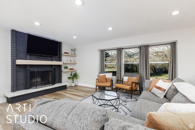 Living room featuring a fireplace, wood finished floors, baseboards, and recessed lighting | Image 7