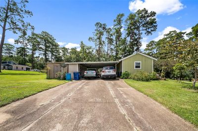 Two car carport and double wide driveway. | Image 2