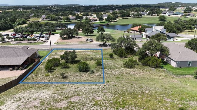 Aerial perspective of suburban area featuring a nearby body of water and property boundaries highlighted | Image 6