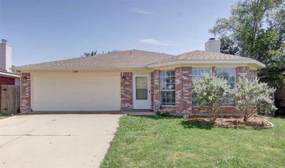 Single story home with a garage and a front yard | Image 1