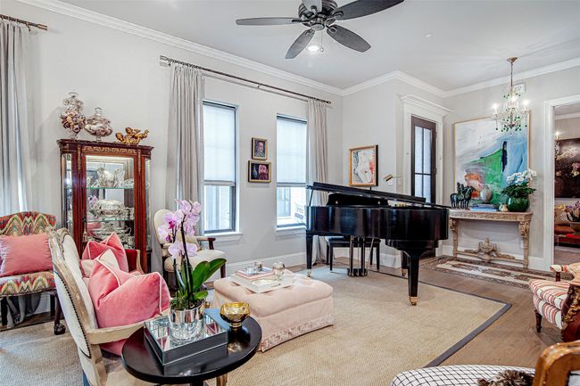 Living area with ornamental molding, baseboards, a ceiling fan, and wood finished floors | Image 8
