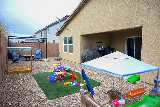 Back of house with stucco siding, a patio area, and a fenced backyard | Image 30