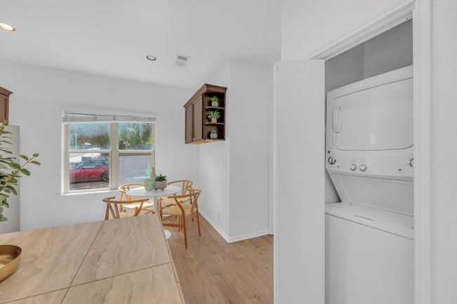 Laundry area with stacked washer / drying machine, light wood-type flooring, and recessed lighting | Image 27