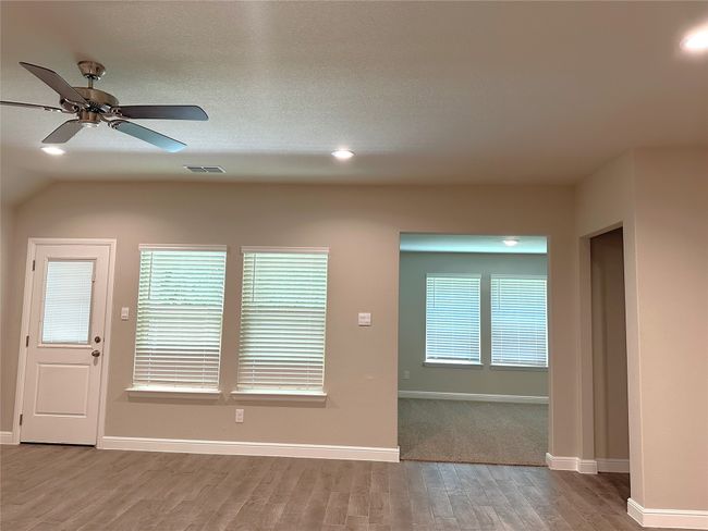 Unfurnished room with wood finished floors, ceiling fan, and recessed lighting | Image 5