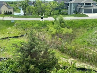 View of yard featuring a water view and a garage | Image 3