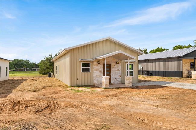 View of front facade featuring central AC unit and stone siding | Image 4