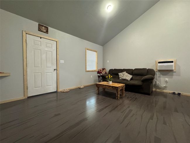 Living room with lofted ceiling and dark wood finished floors | Image 11
