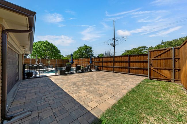 View of patio / terrace with a gate, a fenced backyard, and a fenced in pool | Image 16