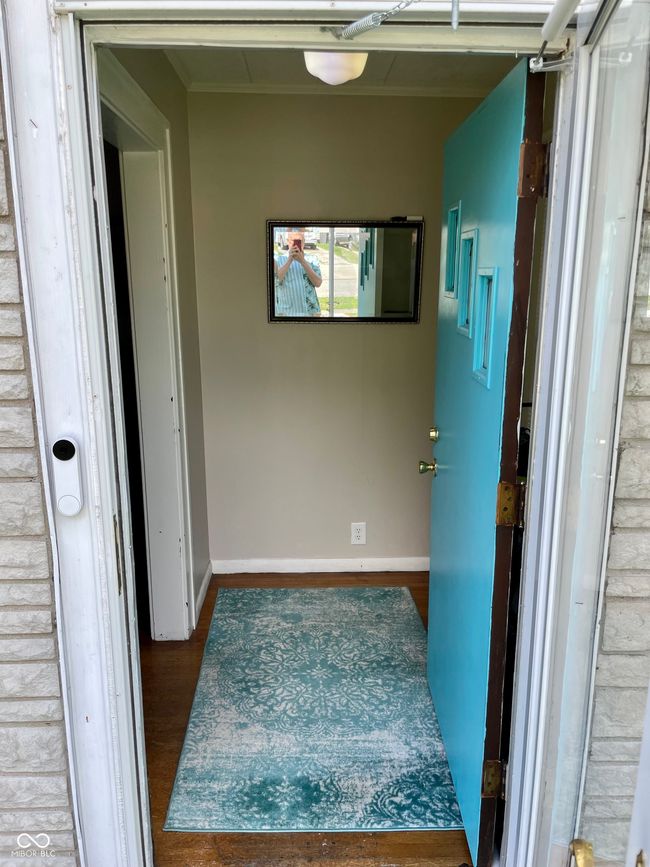 hall featuring wood finished floors and baseboards | Image 4
