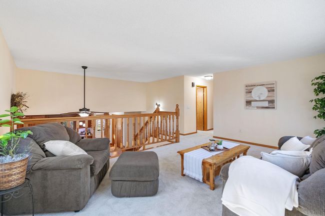 Hide away, or stay in the conversation with this upper level living room. | Image 13