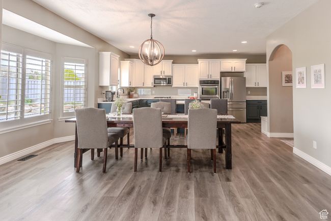Dining space featuring recessed lighting, light wood-style floors, baseboards, visible vents, and a notable chandelier | Image 6