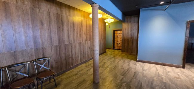 Hallway featuring wood walls and wood finished floors | Image 10