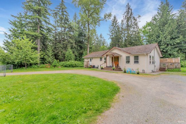 View of front of home with curved driveway and a front lawn | Image 19