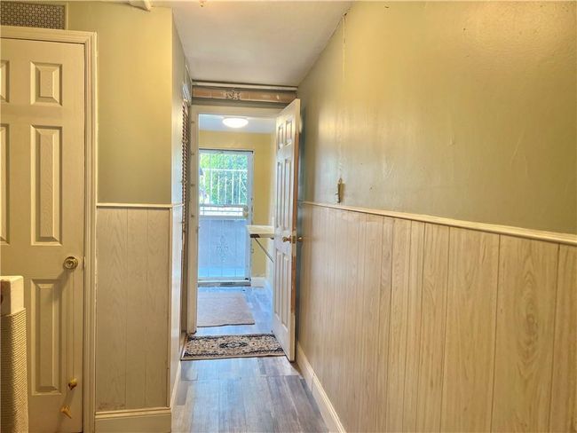 Basement Hallway view of basement front entrance with wood-type flooring | Image 17