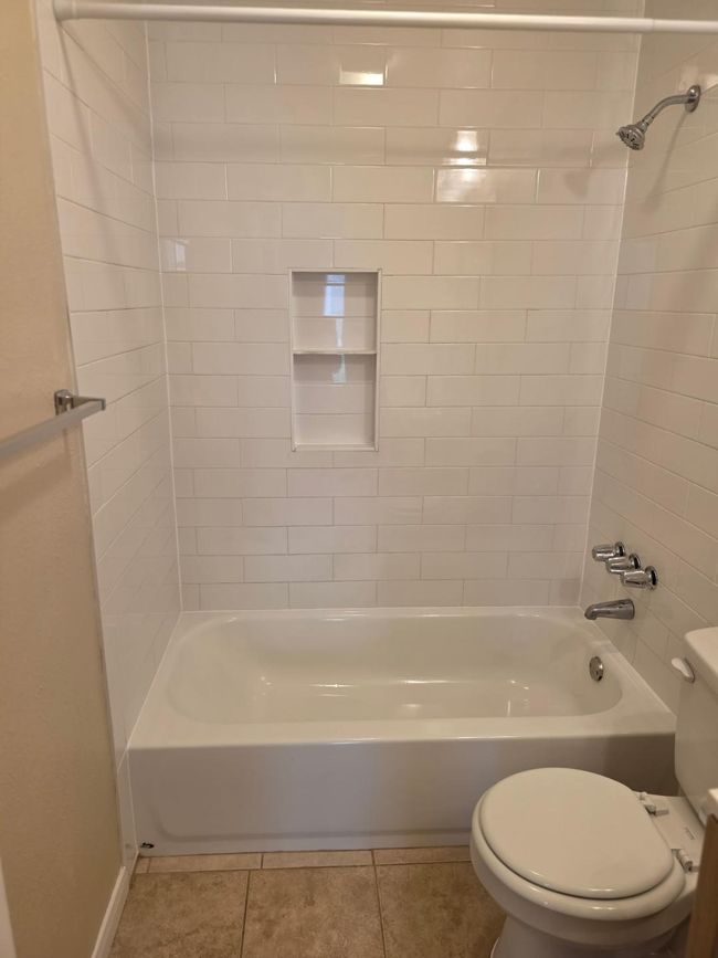 Bathroom featuring shower / washtub combination and tile patterned flooring | Image 14