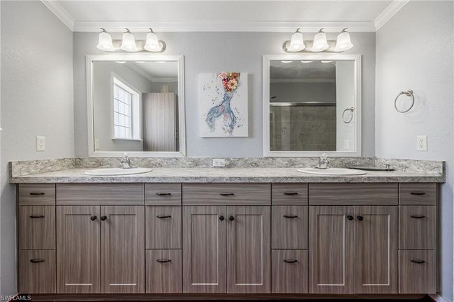 Full bathroom featuring ornamental molding, double vanity, and a sink | Image 25