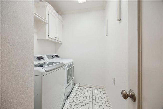 Nice sized laundry too with recent tile and plenty of storage. | Image 27