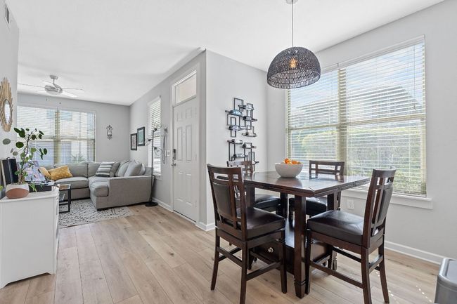 Dining area with plenty of natural light, light wood-style flooring, and a ceiling fan | Image 12