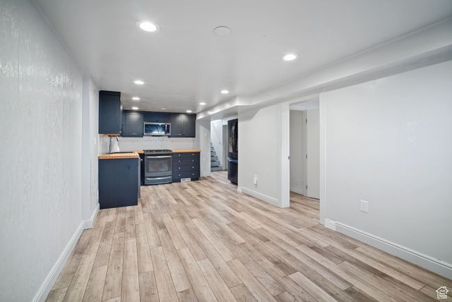 Unfurnished living room with light wood-type flooring, recessed lighting, and baseboards | Image 17