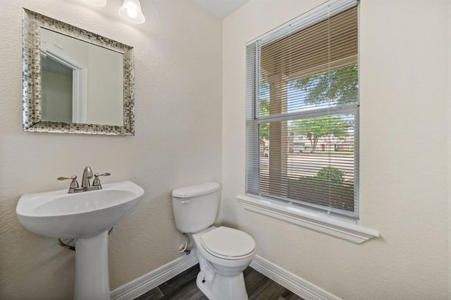 Main floor powder room with updated fixtures and natural light. | Image 10