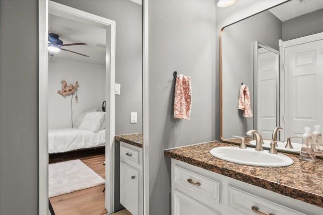 A Jack-and-Jill style bathroom connects secondary bedrooms with double sinks, plenty of counter space, and stylish finishes. | Image 29