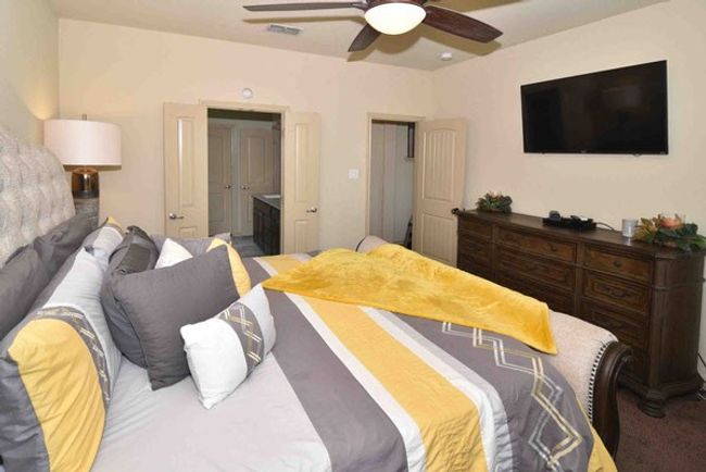 Carpeted bedroom with a ceiling fan | Image 17