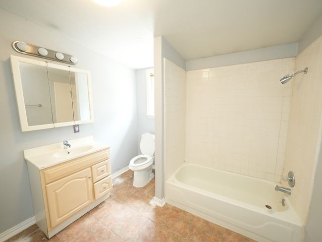 Bathroom featuring vanity, shower / washtub combination, and tile patterned floors | Image 19