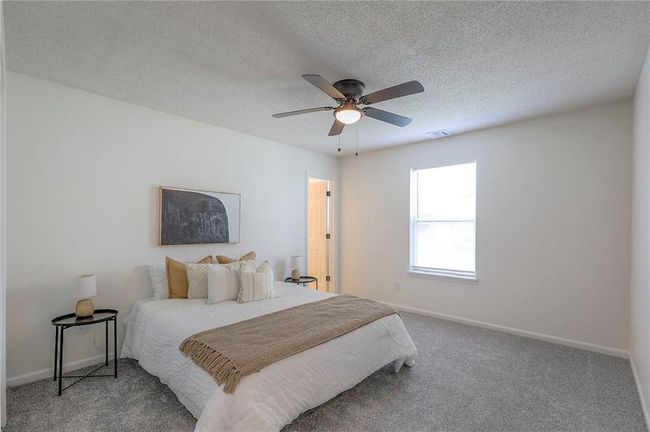 Carpeted bedroom featuring a textured ceiling and ceiling fan | Image 10