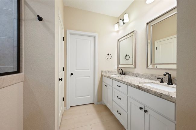 Bathroom featuring double vanity and tile patterned floors | Image 13