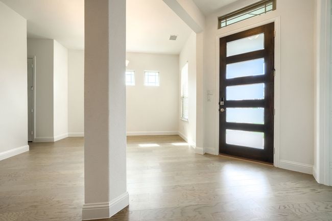 Entryway with visible vents, baseboards, and wood finished floors | Image 5