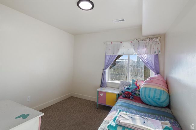 Bedroom with visible vents, baseboards, and carpet | Image 35