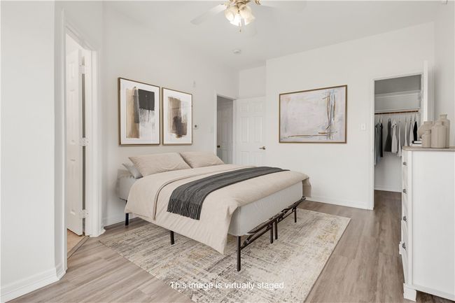 Bedroom featuring a closet, baseboards, a walk in closet, and light wood-style floors | Image 6